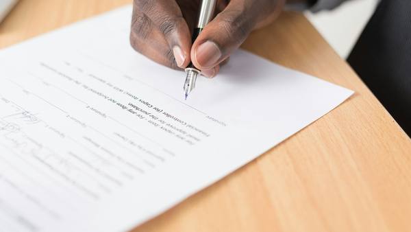 Firma de un contrato de trabajo con pluma estilográfica